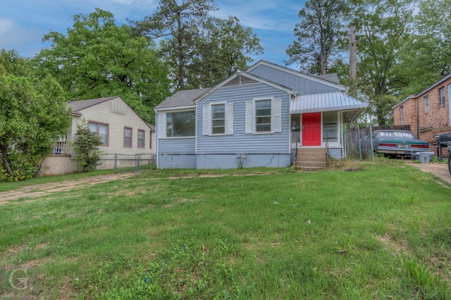 bungalow with a front lawn and fence