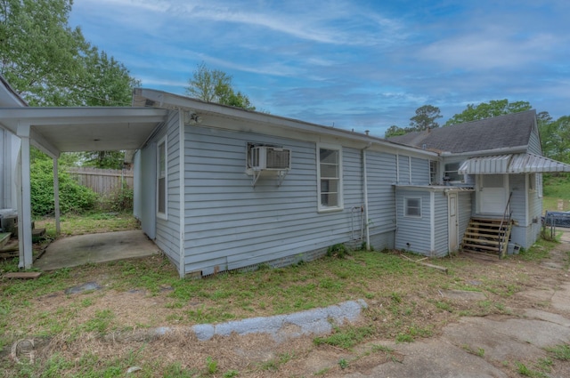 view of property exterior featuring entry steps and fence