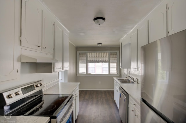 kitchen featuring ornamental molding, white cabinetry, under cabinet range hood, a sink, and stainless steel appliances