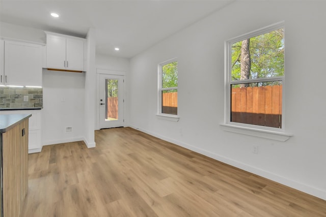 interior space with recessed lighting, light wood-style floors, and baseboards