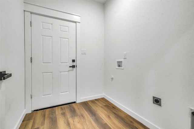 laundry area featuring baseboards, washer hookup, laundry area, wood finished floors, and electric dryer hookup