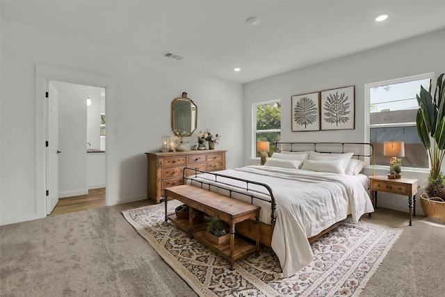 carpeted bedroom with visible vents and recessed lighting