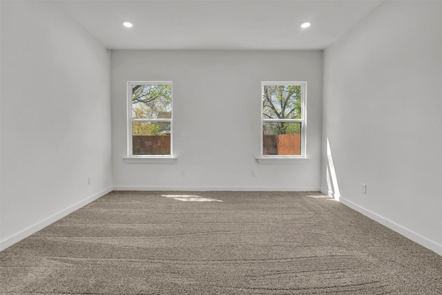 carpeted empty room with baseboards, recessed lighting, and plenty of natural light