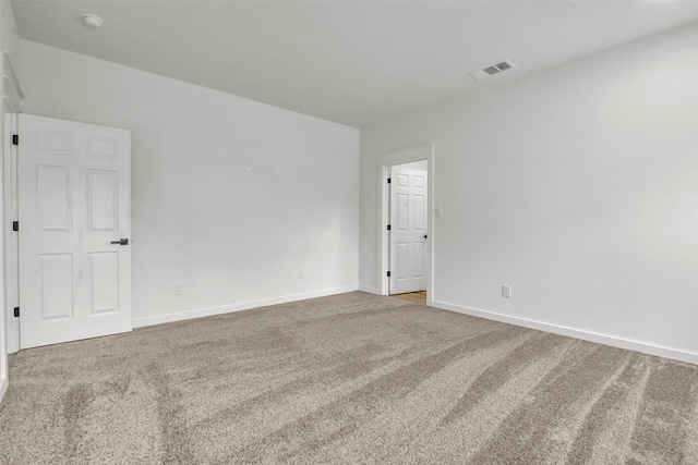 carpeted empty room with baseboards and visible vents