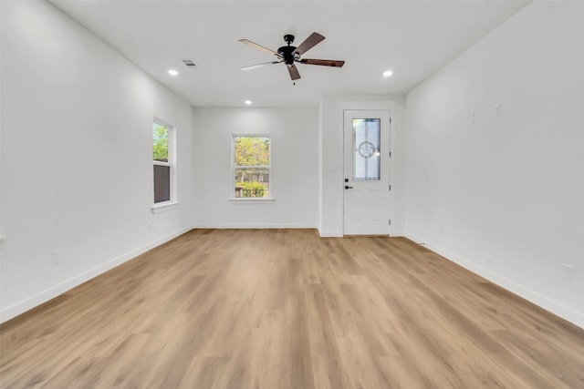 unfurnished room featuring ceiling fan, light wood-type flooring, visible vents, recessed lighting, and baseboards