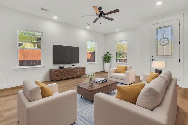 living room featuring visible vents, recessed lighting, and wood finished floors