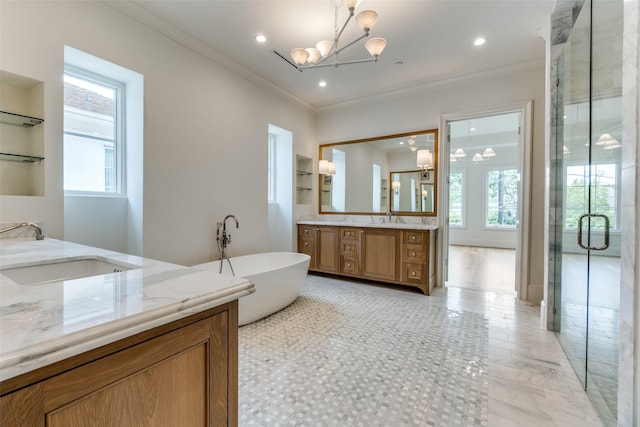 full bath featuring a chandelier, plenty of natural light, ornamental molding, a stall shower, and two vanities