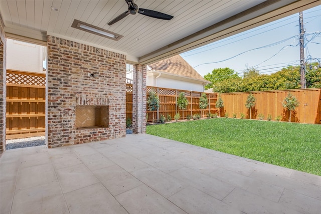 view of patio / terrace with an outdoor brick fireplace and a ceiling fan