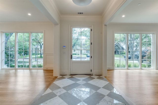 doorway featuring ornamental molding and baseboards