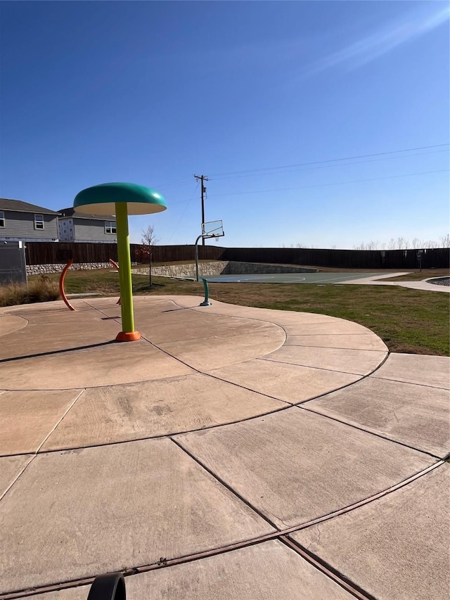 view of community featuring community basketball court and fence