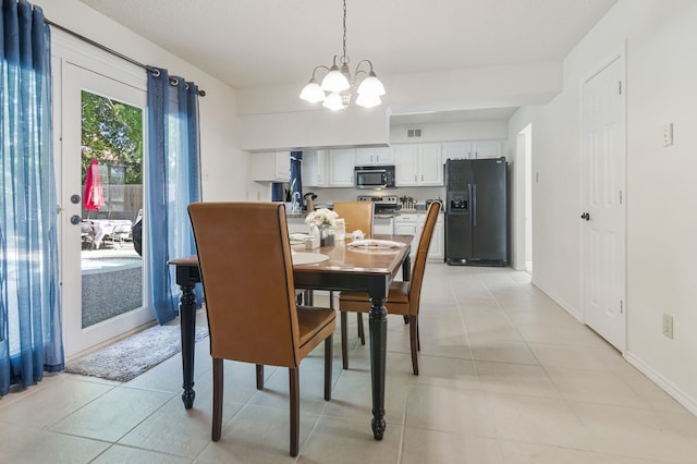 dining space featuring light tile patterned floors, baseboards, a notable chandelier, and visible vents