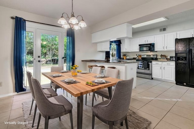 dining space featuring visible vents, a notable chandelier, and light tile patterned floors