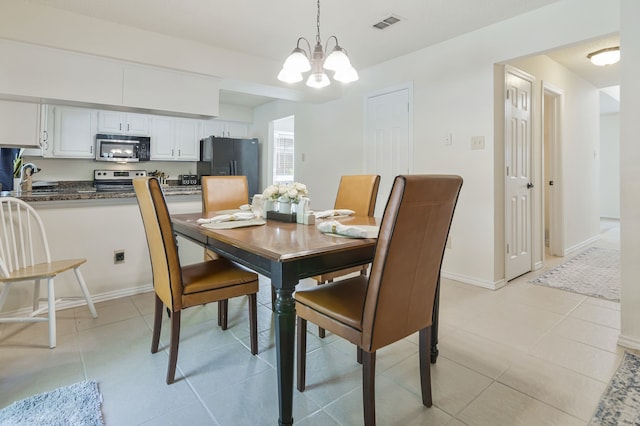dining room featuring visible vents, an inviting chandelier, baseboards, and light tile patterned floors