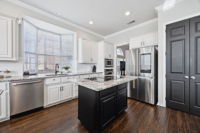 1500 Shropshire St, Keller, TX 76248 - kitchen with appliances with stainless steel finishes, a sink, white cabinetry, a center island, and crown molding