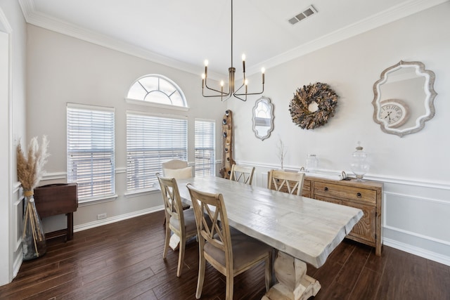 dining room featuring a chandelier, visible vents, ornamental molding, and dark wood finished floors