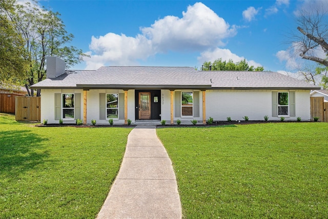 ranch-style home with a chimney, a front lawn, brick siding, central AC unit, and fence