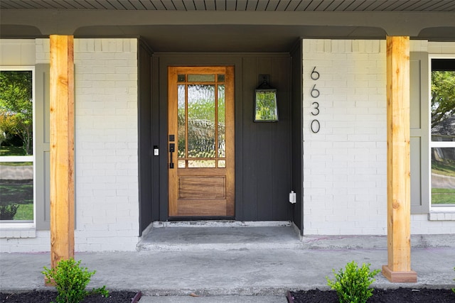 doorway to property with brick siding