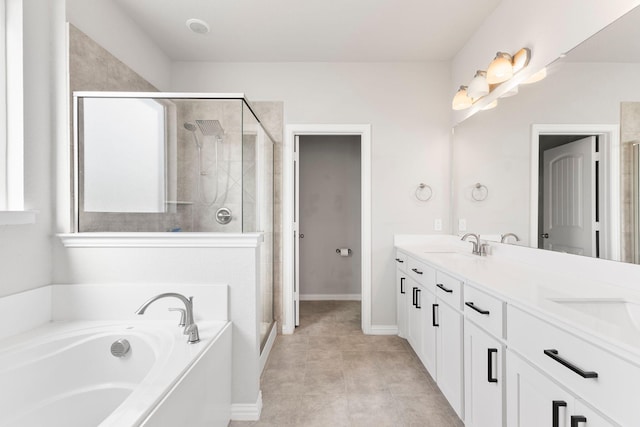 141 York Bridge Rd, Springtown, TX 76082 - bathroom with double vanity, a shower stall, a garden tub, and baseboards