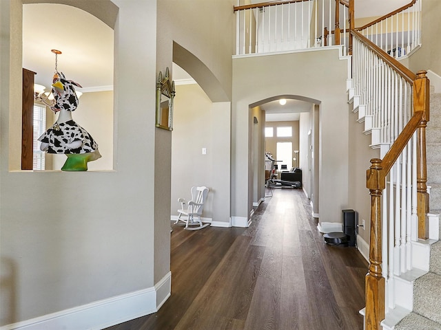 2009 Elmsted Dr, Allen, TX 75013 - foyer entrance with arched walkways, dark wood-style flooring, baseboards, and stairway