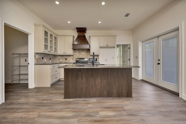 2312 Royce Dr, Arlington, TX 76016 - kitchen with custom range hood, french doors, stainless steel range with electric stovetop, visible vents, and a sink