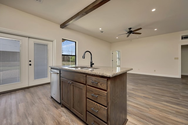 2312 Royce Dr, Arlington, TX 76016 - kitchen featuring stainless steel dishwasher, an island with sink, recessed lighting, wood finished floors, and a sink