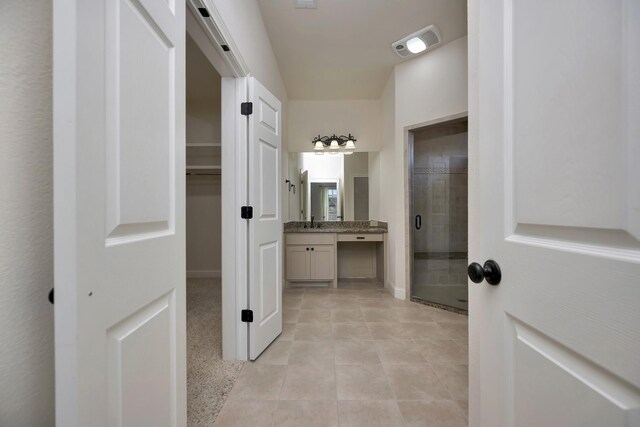 2312 Royce Dr, Arlington, TX 76016 - corridor featuring a sink, visible vents, baseboards, and light tile patterned flooring