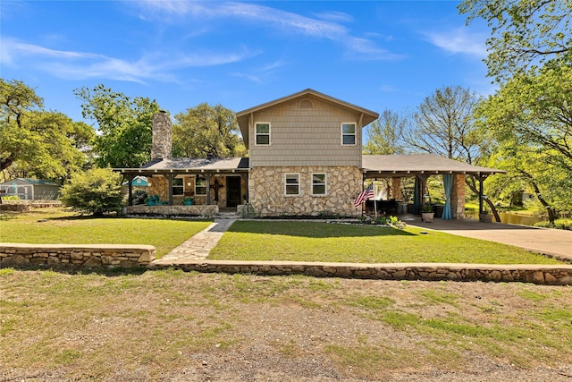 view of front of property featuring a front yard, a carport, stone siding, a chimney, and concrete driveway
