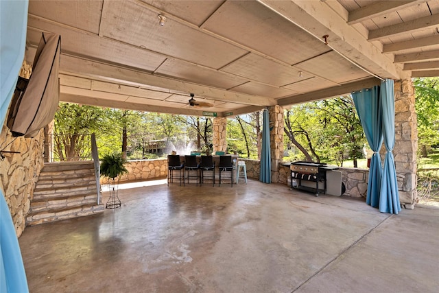 view of patio / terrace featuring a grill, outdoor dry bar, and ceiling fan
