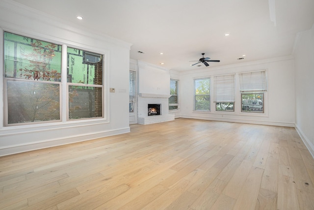 3422 Lovers Ln Unit A, University Park, TX 75225 - unfurnished living room featuring crown molding, baseboards, ceiling fan, light wood finished floors, and a fireplace