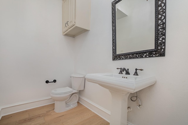 3422 Lovers Ln Unit A, University Park, TX 75225 - bathroom with wood finished floors, baseboards, and toilet