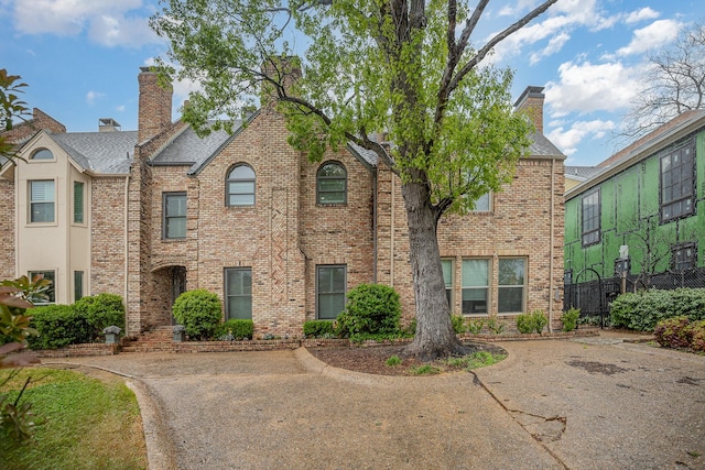 3422 Lovers Ln Unit A, University Park, TX 75225 - view of front facade with a chimney, brick siding, and a shingled roof