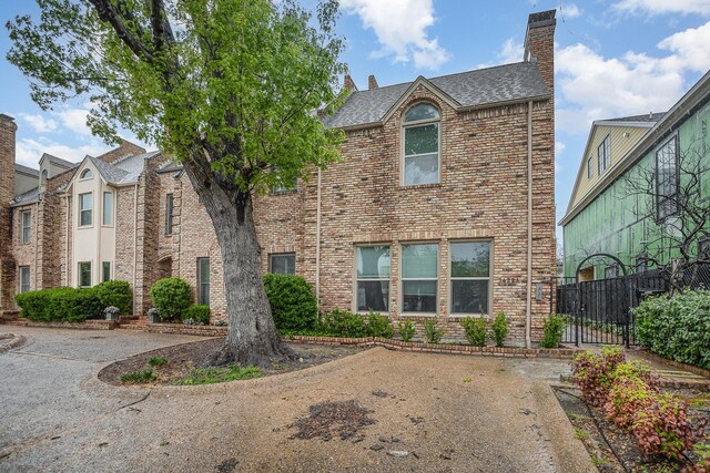 3422 Lovers Ln Unit A, University Park, TX 75225 - traditional-style home with a chimney, brick siding, and roof with shingles