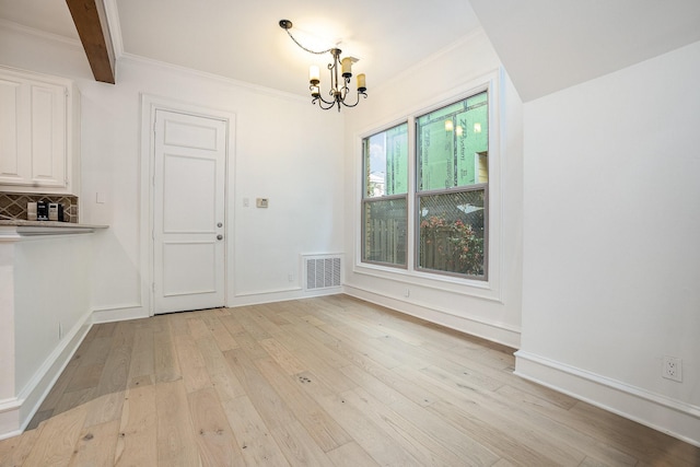 3422 Lovers Ln Unit A, University Park, TX 75225 - unfurnished dining area featuring a chandelier, light wood-type flooring, crown molding, and baseboards