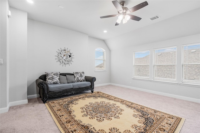 sitting room featuring visible vents, baseboards, a ceiling fan, light colored carpet, and lofted ceiling