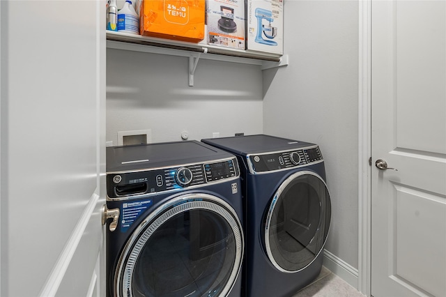 laundry area featuring washer and dryer, laundry area, and baseboards