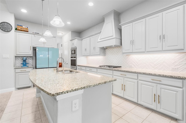 kitchen with a sink, custom range hood, light tile patterned floors, and stainless steel appliances