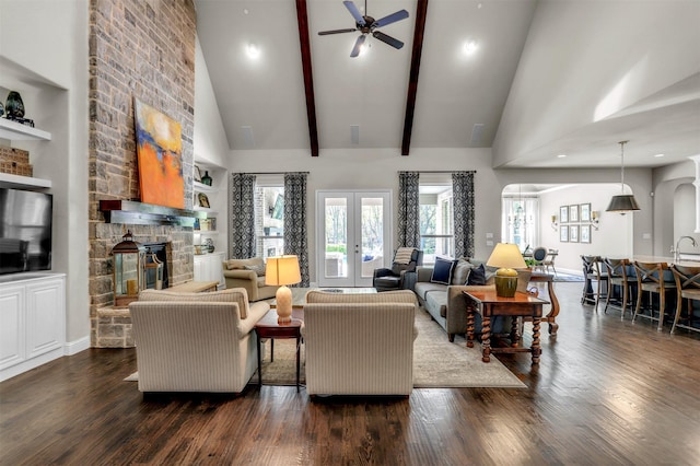 living room featuring high vaulted ceiling, a fireplace, dark wood finished floors, and ceiling fan