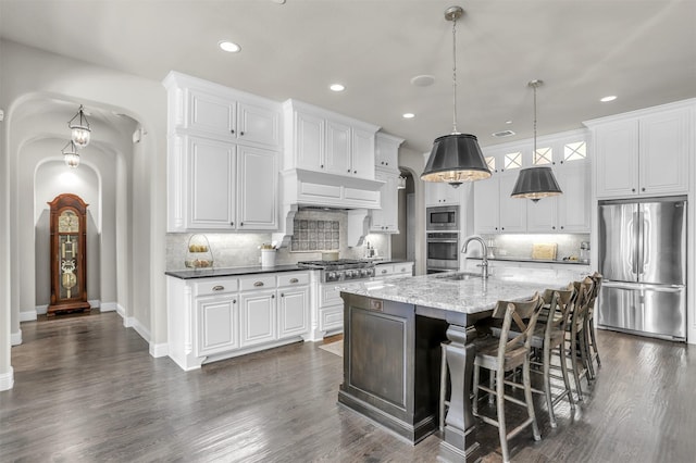 kitchen with recessed lighting, decorative backsplash, a sink, and appliances with stainless steel finishes