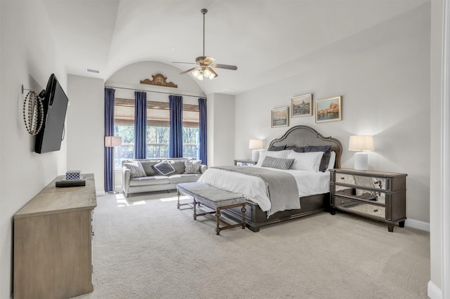 bedroom with visible vents, baseboards, ceiling fan, light carpet, and lofted ceiling