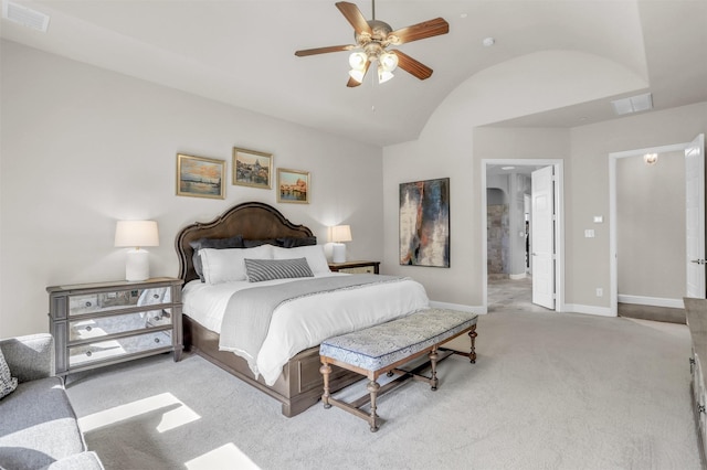 bedroom with visible vents, baseboards, light colored carpet, and vaulted ceiling