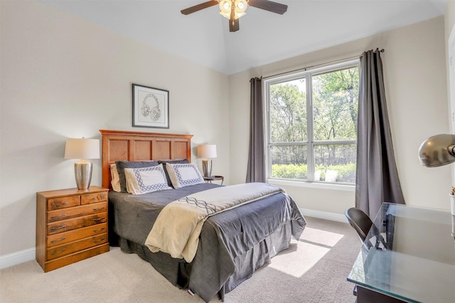 bedroom featuring baseboards, vaulted ceiling, ceiling fan, and light carpet