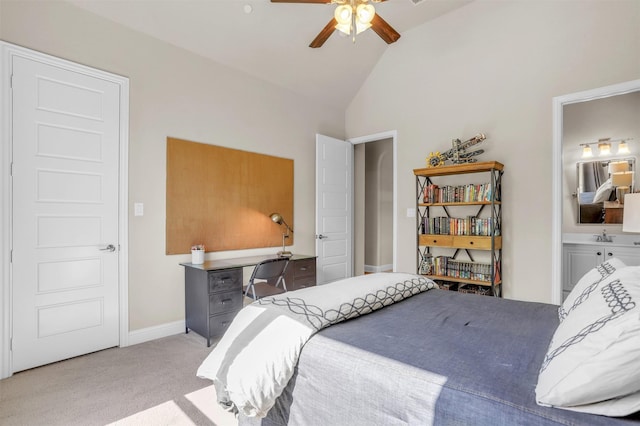 carpeted bedroom featuring high vaulted ceiling, baseboards, and ensuite bath