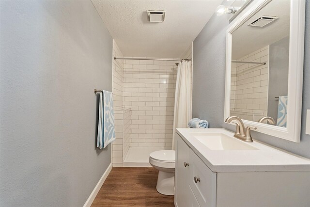 5269 Alta Vis, Malakoff, TX 75148 - full bath featuring toilet, vanity, a tile shower, wood finished floors, and baseboards