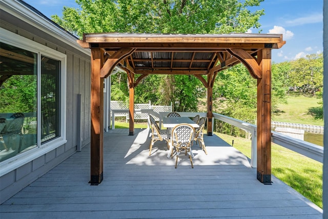 wooden deck with a gazebo and outdoor dining area
