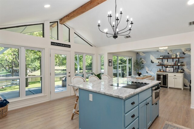 kitchen with visible vents, oven, black electric cooktop, wine cooler, and vaulted ceiling with beams