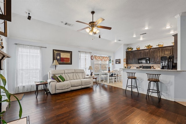 5929 Black Bass Dr, Fort Worth, TX 76179 - living room featuring wood-type flooring, visible vents, vaulted ceiling, and ceiling fan