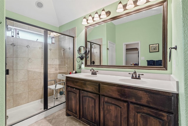 5929 Black Bass Dr, Fort Worth, TX 76179 - full bathroom featuring tile patterned flooring, vaulted ceiling, a sink, a stall shower, and double vanity