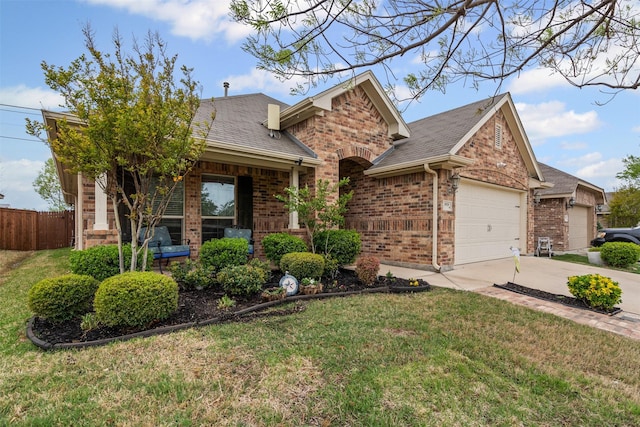 5929 Black Bass Dr, Fort Worth, TX 76179 - view of front of home featuring driveway, an attached garage, a front yard, brick siding, and fence