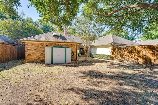 3305 Oak Trail Dr, Rowlett, TX 75088 - back of house with fence, an outbuilding, a shed, and roof with shingles