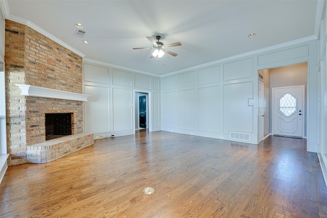 3305 Oak Trail Dr, Rowlett, TX 75088 - living room with ceiling fan, light wood finished floors, a decorative wall, visible vents, and ornamental molding